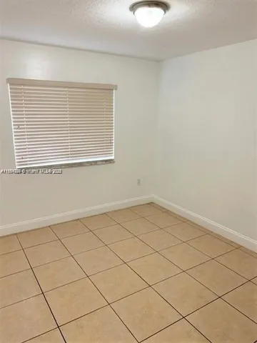 a view of a kitchen with cabinet and a refrigerator