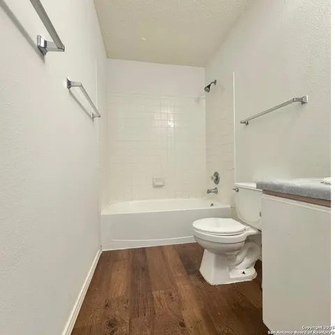 a bathroom with a toilet and a bath tub