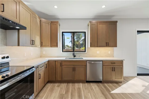 a kitchen with a sink stove and cabinets