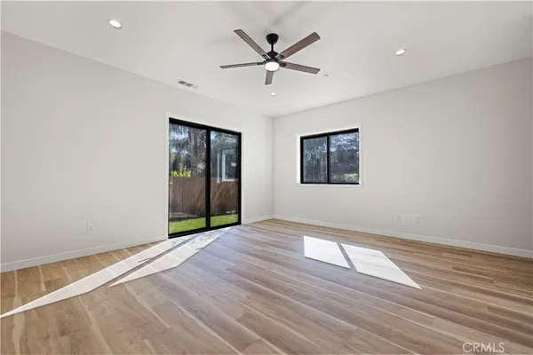 wooden floor in an empty room with a window