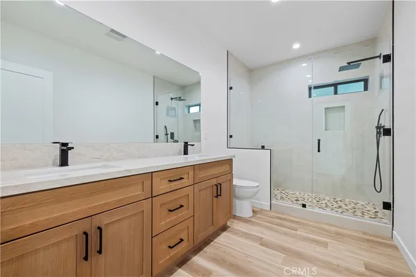 a spacious bathroom with double sink and a shower