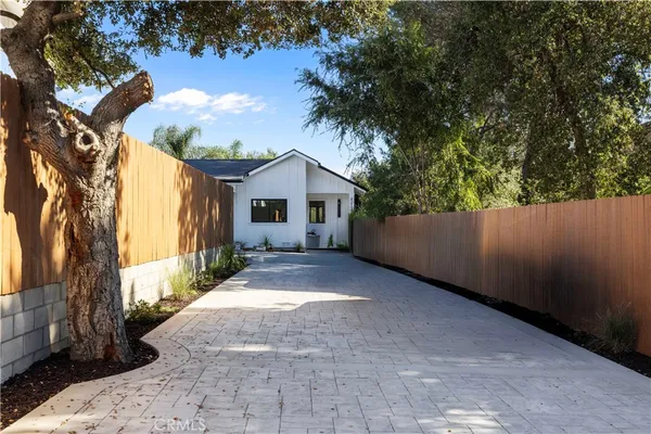 a view of a house with a backyard