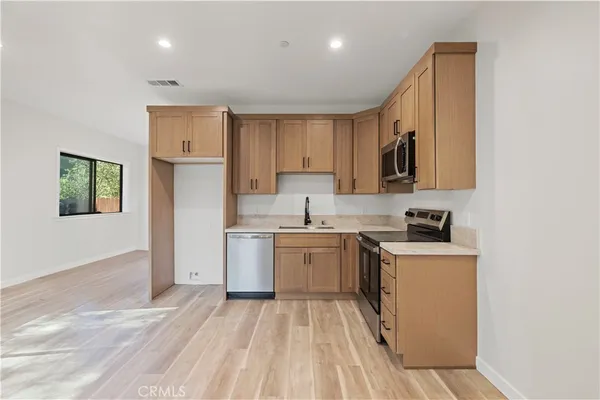 a kitchen with a sink stove and cabinets