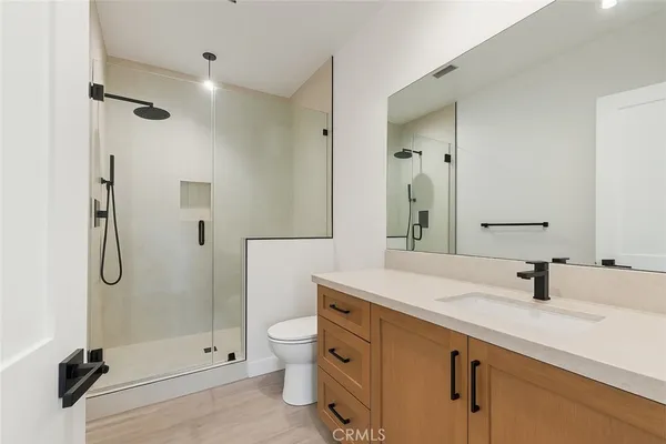 a bathroom with a sink shower and a mirror