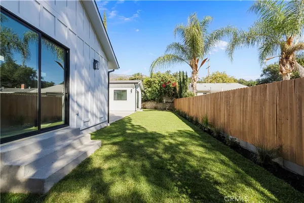 a view of backyard with swimming pool and seating