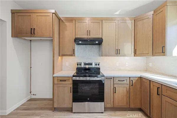a kitchen with stainless steel appliances granite countertop a stove and a refrigerator