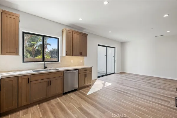 a view of a kitchen with a sink and window
