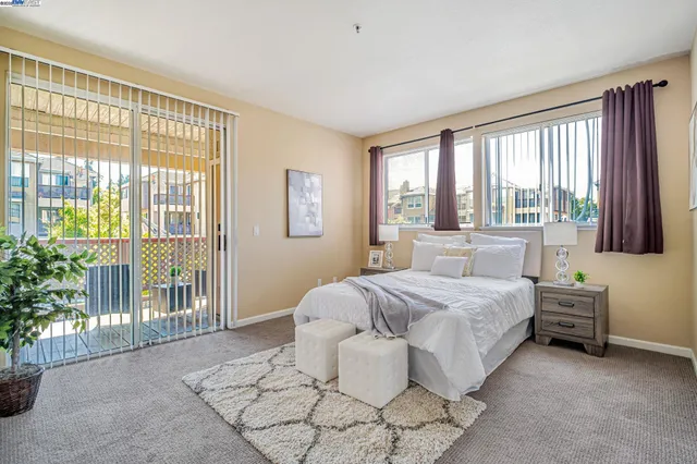 a bedroom with a bed and a painting on the wall