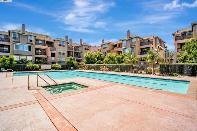 a living room with furniture and large windows