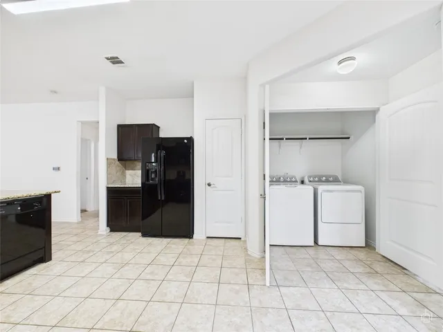 a kitchen with a refrigerator and a sink