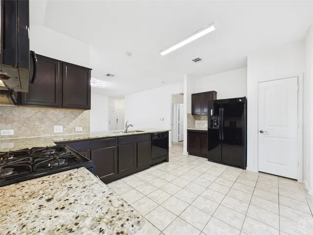 an empty room with fan and windows