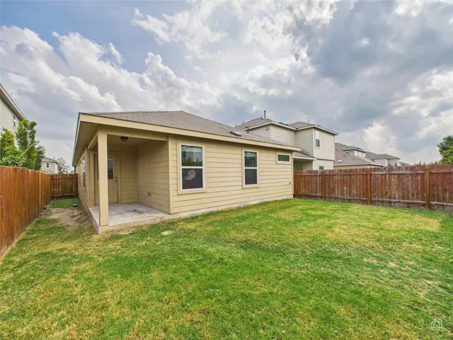 a view of a backyard with plants and a garden