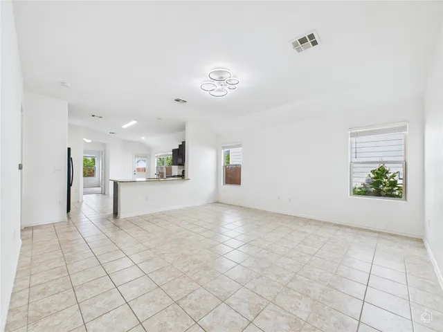 a view of an empty room with a kitchen
