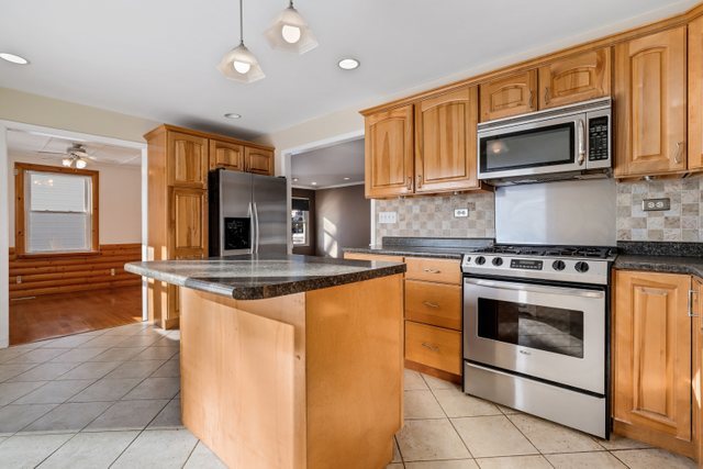 307 Oakwood Road Vernon Hills, IL 60061 - Photo 15 of 28 a kitchen with stainless steel appliances granite countertop a stove top oven microwave and cabinets