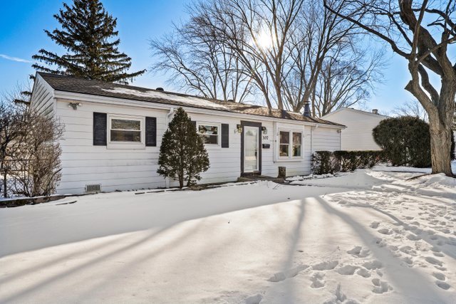 307 Oakwood Road Vernon Hills, IL 60061 - Photo 2 of 28 a front view of a house with a yard covered with snow and trees