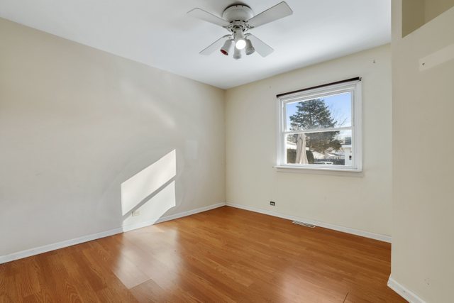 307 Oakwood Road Vernon Hills, IL 60061 - Photo 22 of 28 wooden floor in an empty room with a window