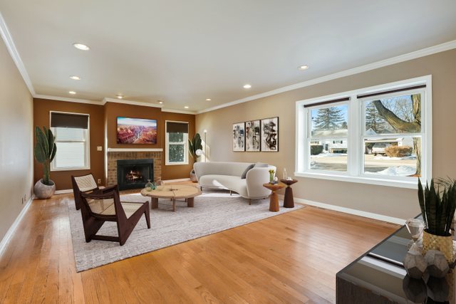 307 Oakwood Road Vernon Hills, IL 60061 - Photo 4 of 28 a living room with furniture a fireplace and a floor to ceiling window