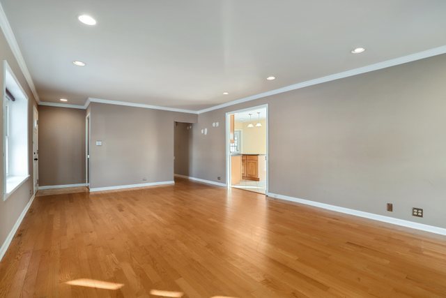 307 Oakwood Road Vernon Hills, IL 60061 - Photo 7 of 28 a view of an empty room with wooden floor and a window
