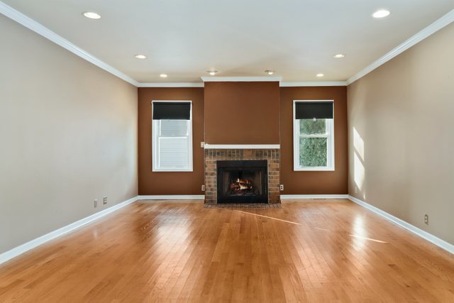 307 Oakwood Road Vernon Hills, IL 60061 - Photo 9 of 28 a view of an empty room with a fireplace and a window