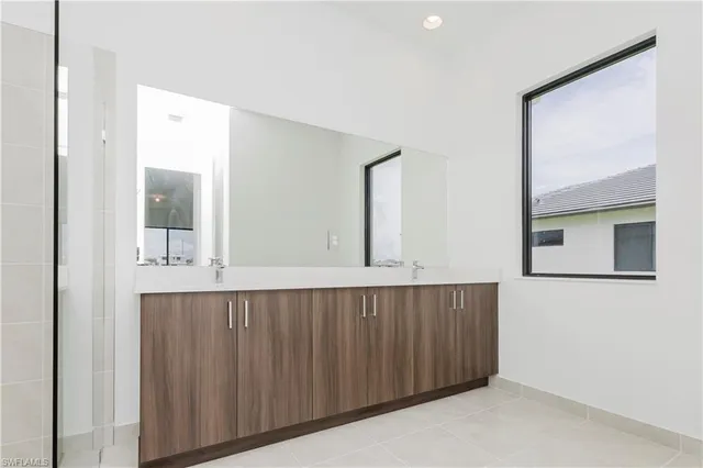 a view of a hallway with wooden cabinet