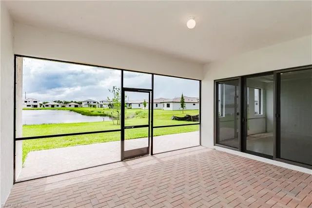 a view of an empty room with glass door and window