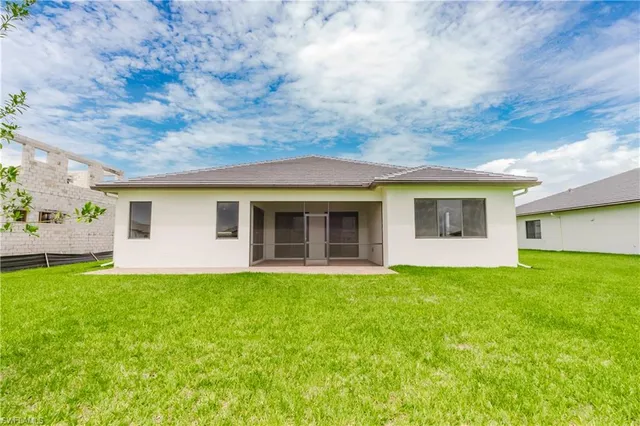 a front view of a house with a garden and yard
