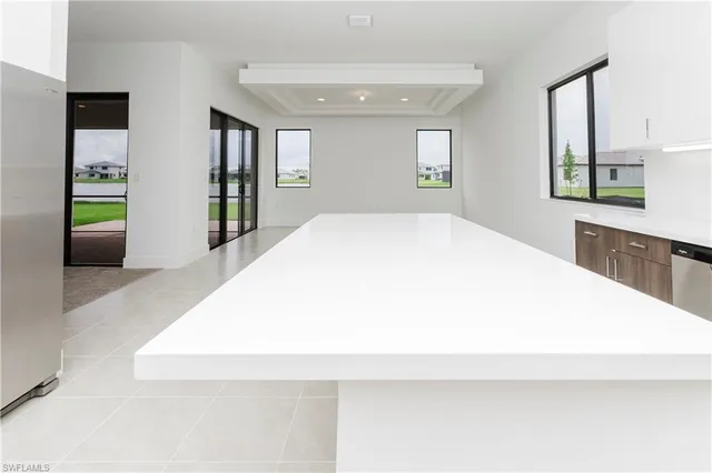 a large white bed in a white room