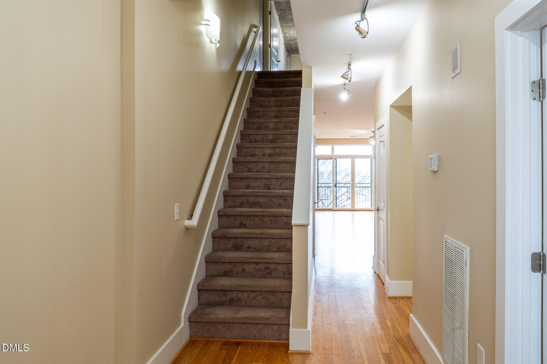 a view of entryway and hall with wooden floor