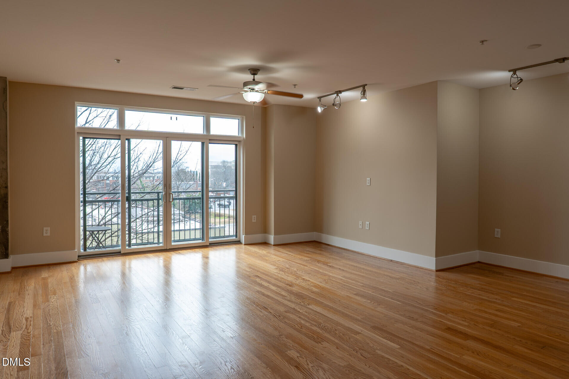 444 South Blount Street, Unit 328 Raleigh, NC 27601 - Photo 2 of 51 a view of an empty room with wooden floor and a window