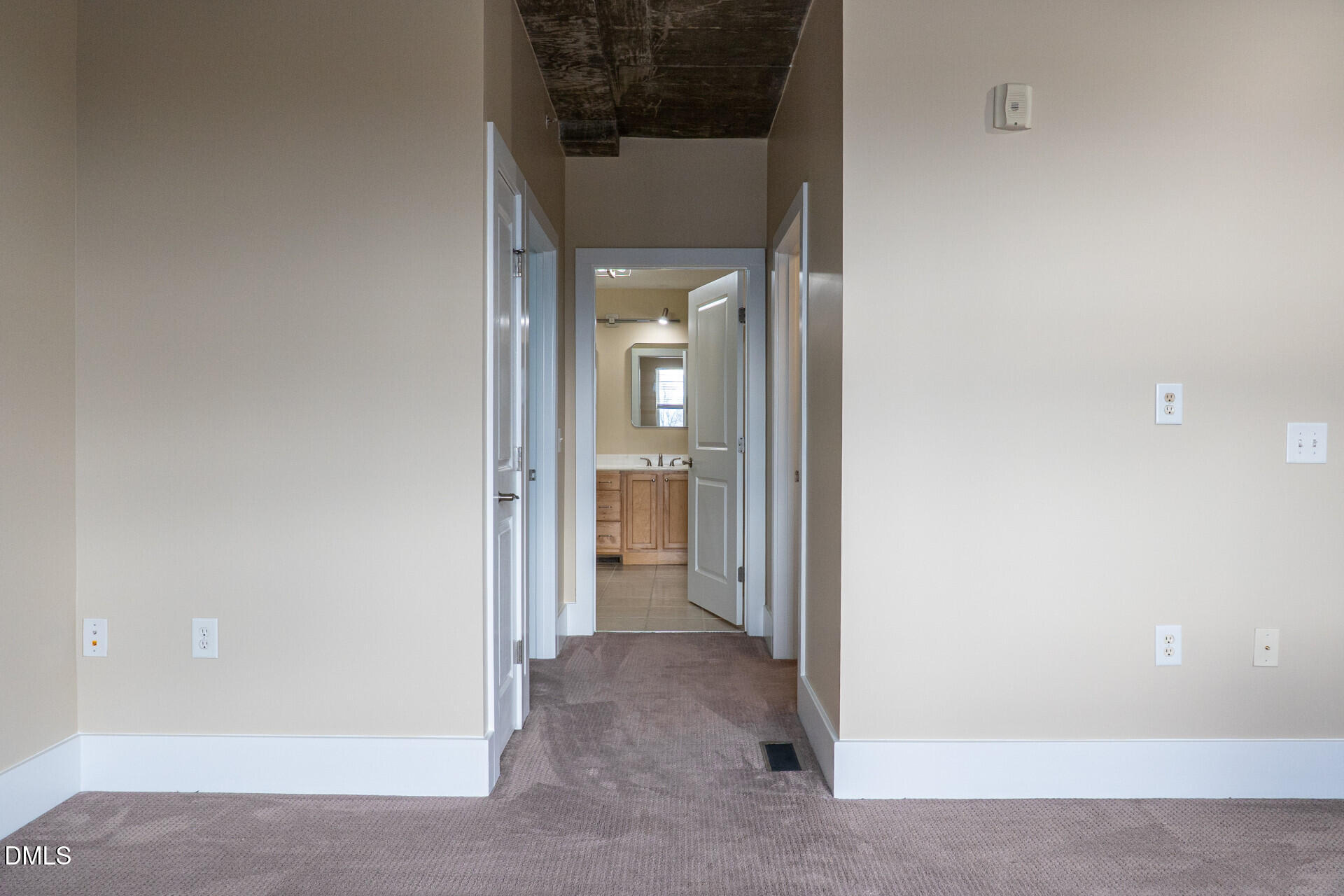 444 South Blount Street, Unit 328 Raleigh, NC 27601 - Photo 23 of 51 a view of a hallway with a white walls and a door