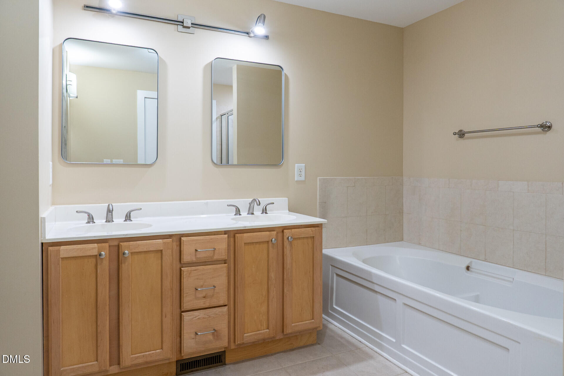 444 South Blount Street, Unit 328 Raleigh, NC 27601 - Photo 29 of 51 a bathroom with a tub a sink and mirror
