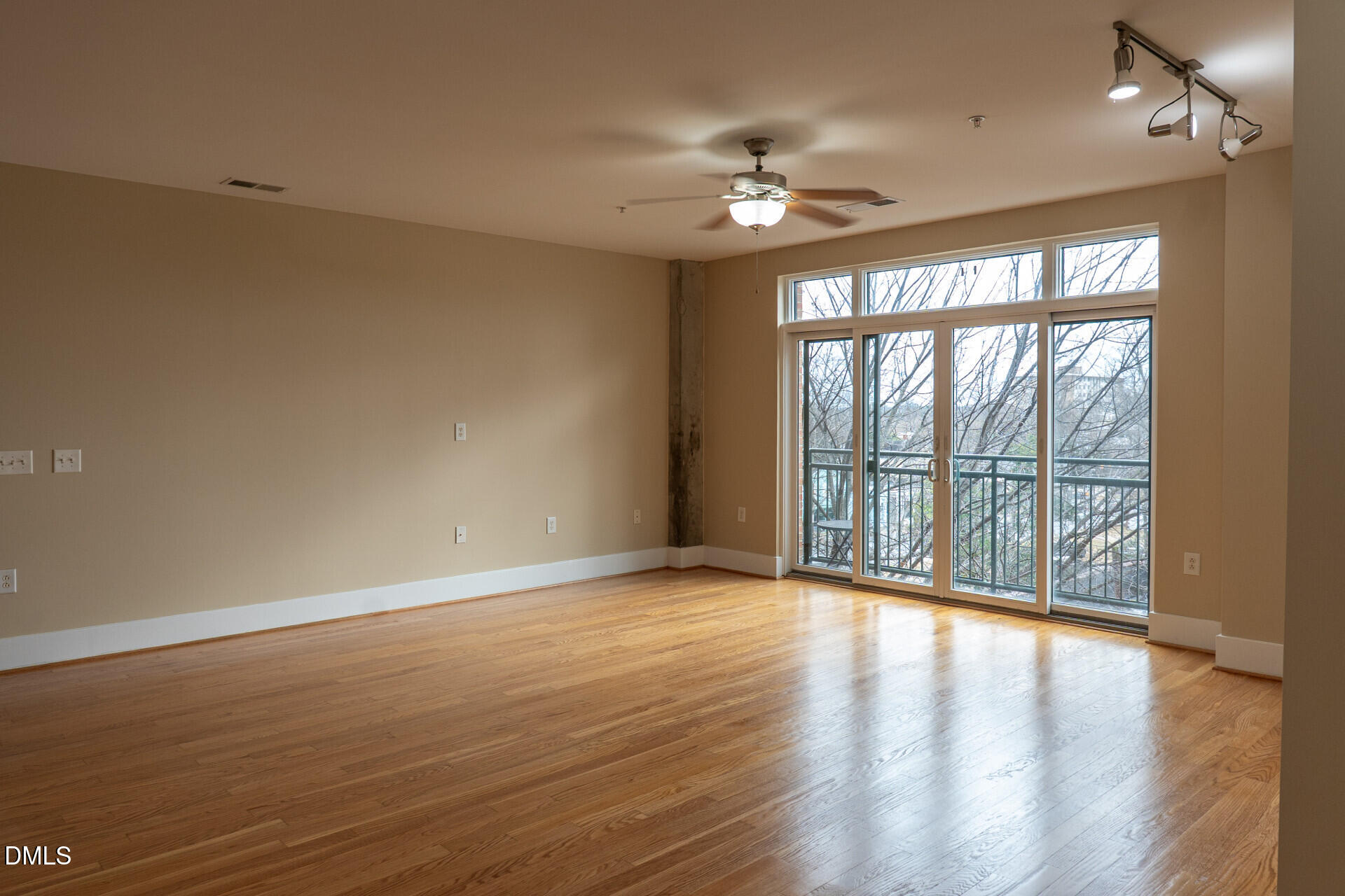 444 South Blount Street, Unit 328 Raleigh, NC 27601 - Photo 3 of 51 a view of an empty room with wooden floor and a window