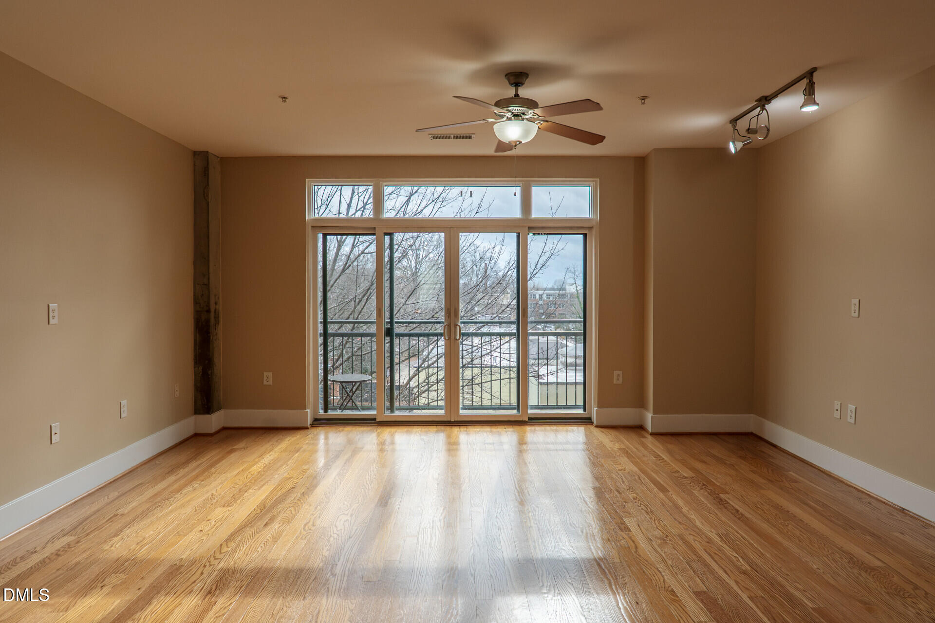 444 South Blount Street, Unit 328 Raleigh, NC 27601 - Photo 4 of 51 a view of an empty room with wooden floor and a window