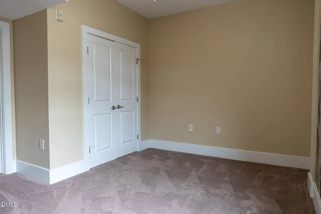 a bathroom with a granite countertop sink mirror vanity and toilet