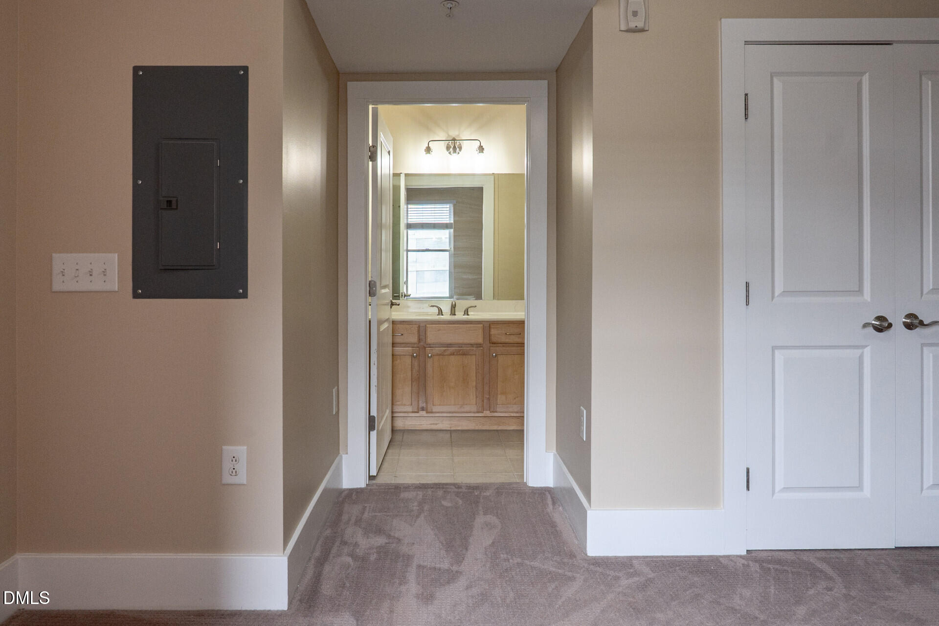 444 South Blount Street, Unit 328 Raleigh, NC 27601 - Photo 45 of 51 a view of a hallway with a wooden cabinet and mirror