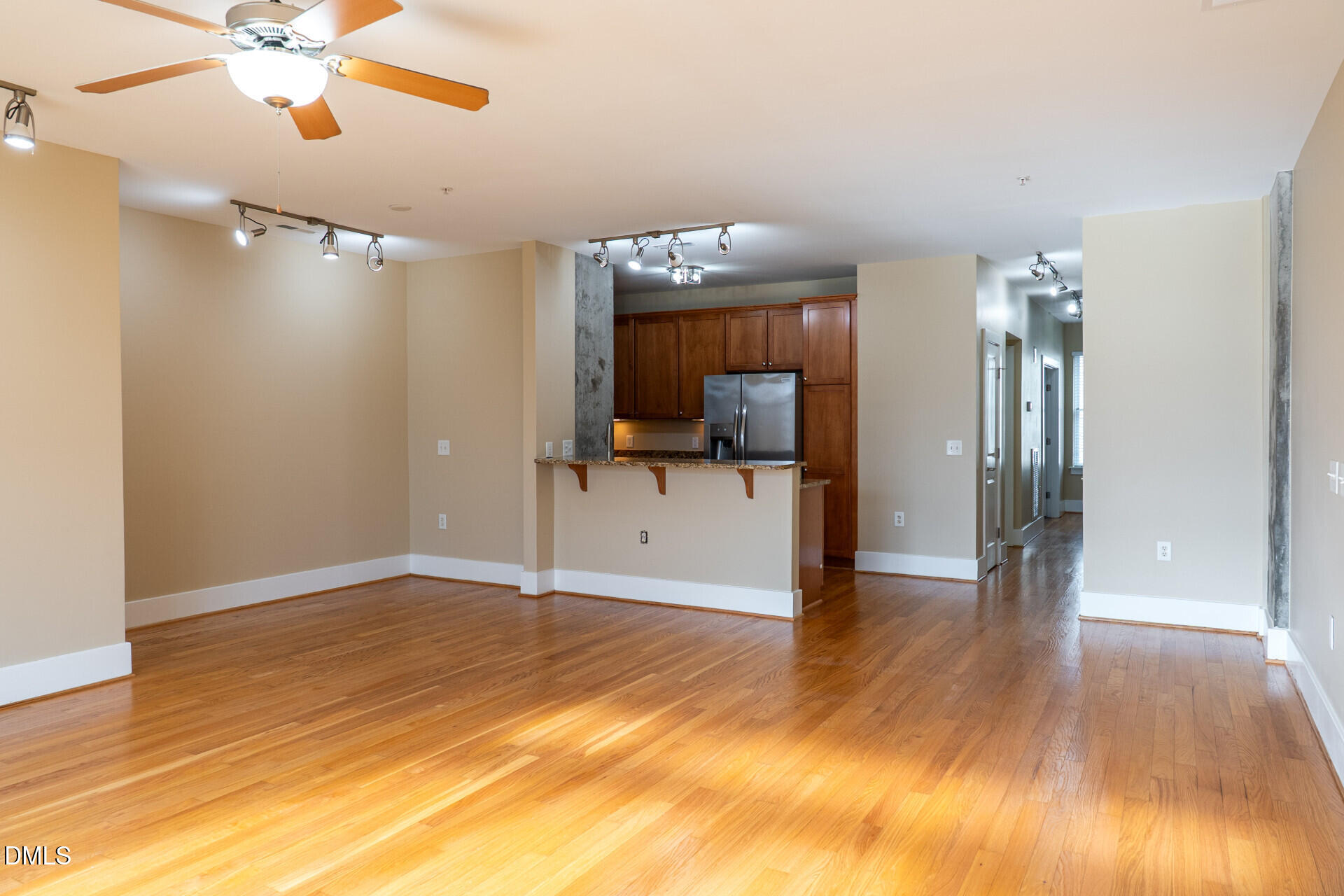 444 South Blount Street, Unit 328 Raleigh, NC 27601 - Photo 8 of 51 a view of a room with wooden floor and a ceiling fan