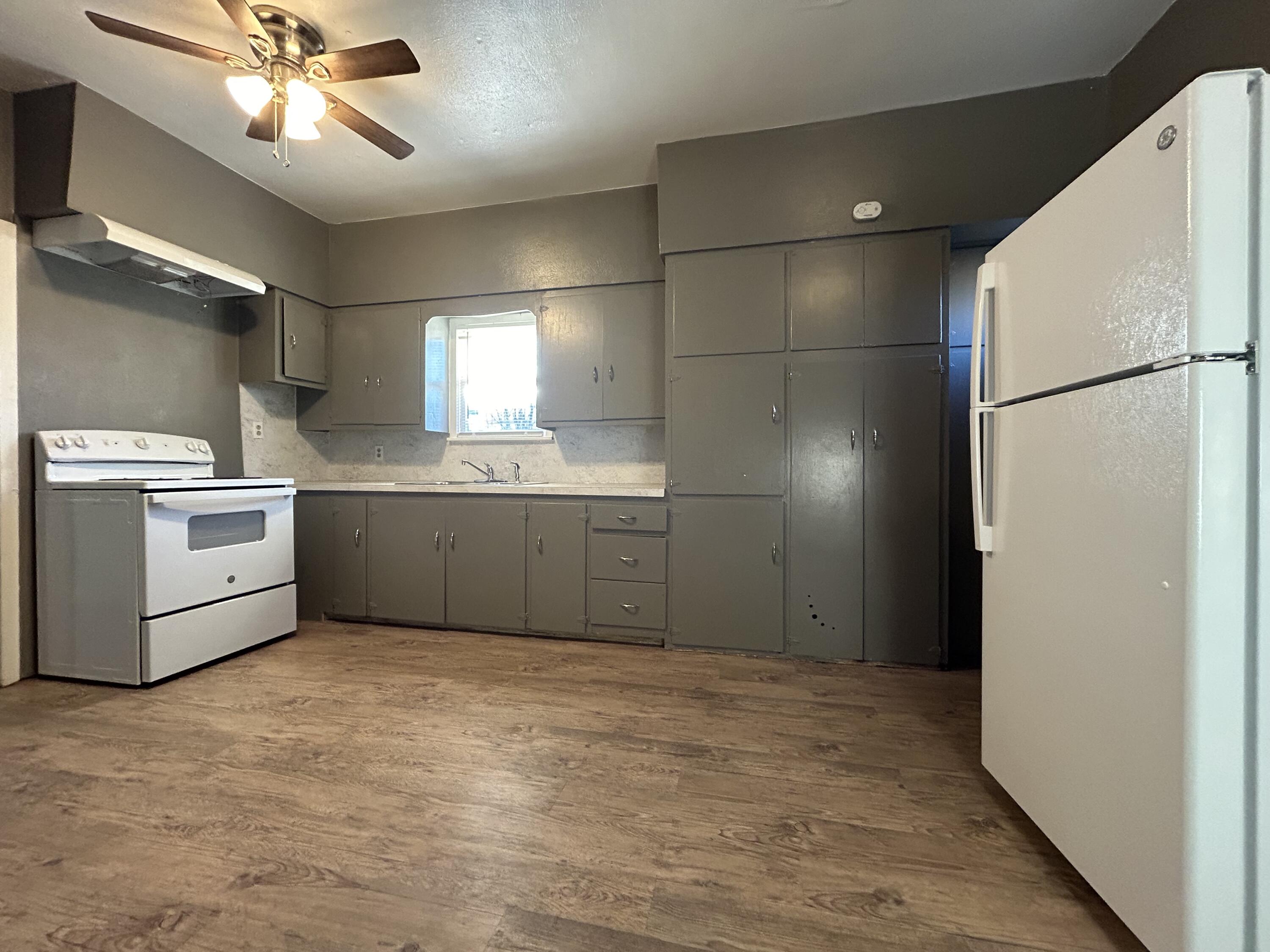 2006 28th Street, Unit B Lubbock, TX 79411 - Photo 3 of 5 a kitchen with stainless steel appliances a refrigerator sink and cabinets