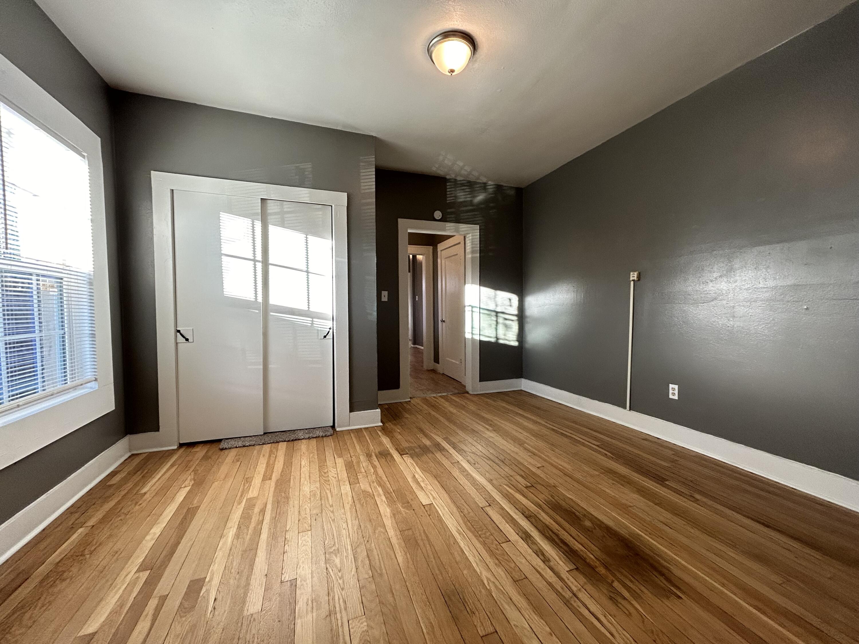 2006 28th Street, Unit B Lubbock, TX 79411 - Photo 4 of 5 a view of empty room with wooden floor
