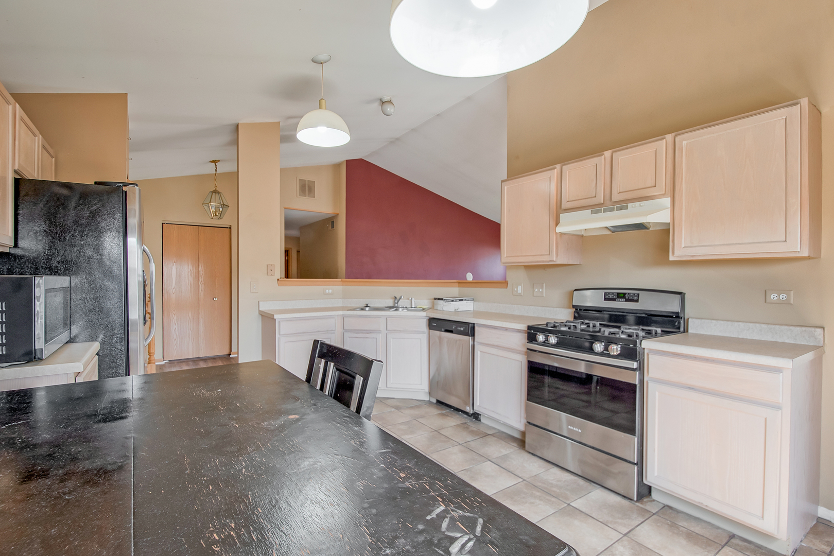 545 North Fox Trail Round Lake, IL 60073 - Photo 4 of 15 a kitchen with granite countertop a stove a sink and a refrigerator