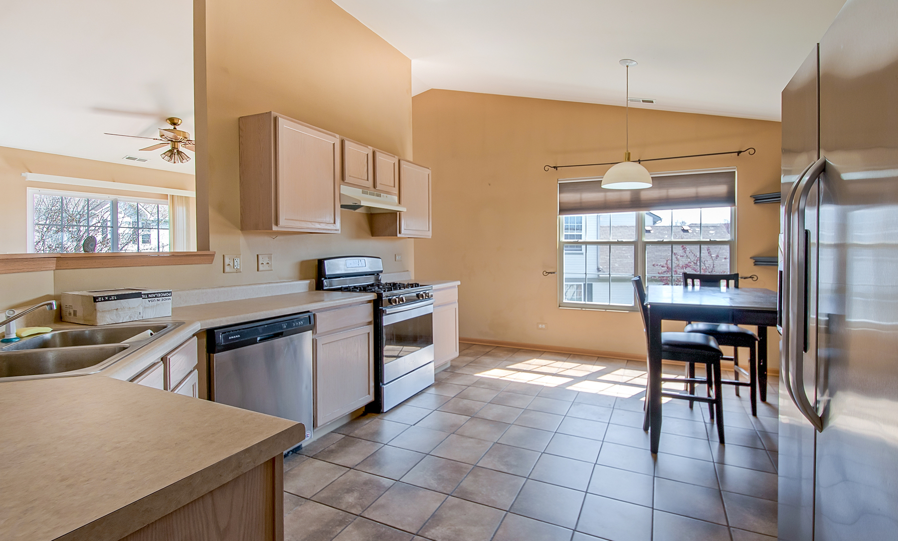 545 North Fox Trail Round Lake, IL 60073 - Photo 5 of 15 a kitchen with granite countertop a stove a sink a counter top space and cabinets