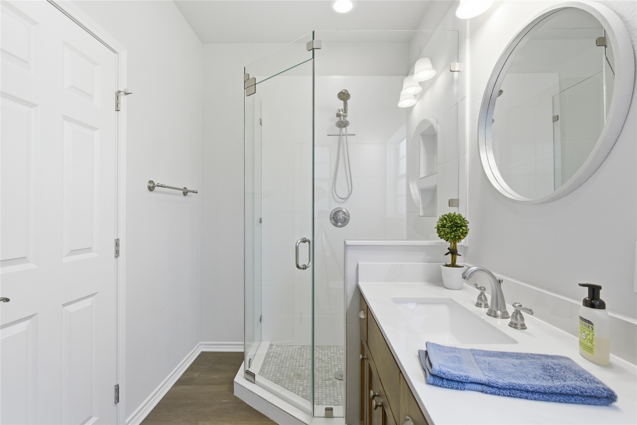 1204 Orlando Road Austin, TX 78733 - Photo 40 of 40 A well-lit bathroom features a glass-enclosed shower alongside a spacious vanity with an undermount sink.