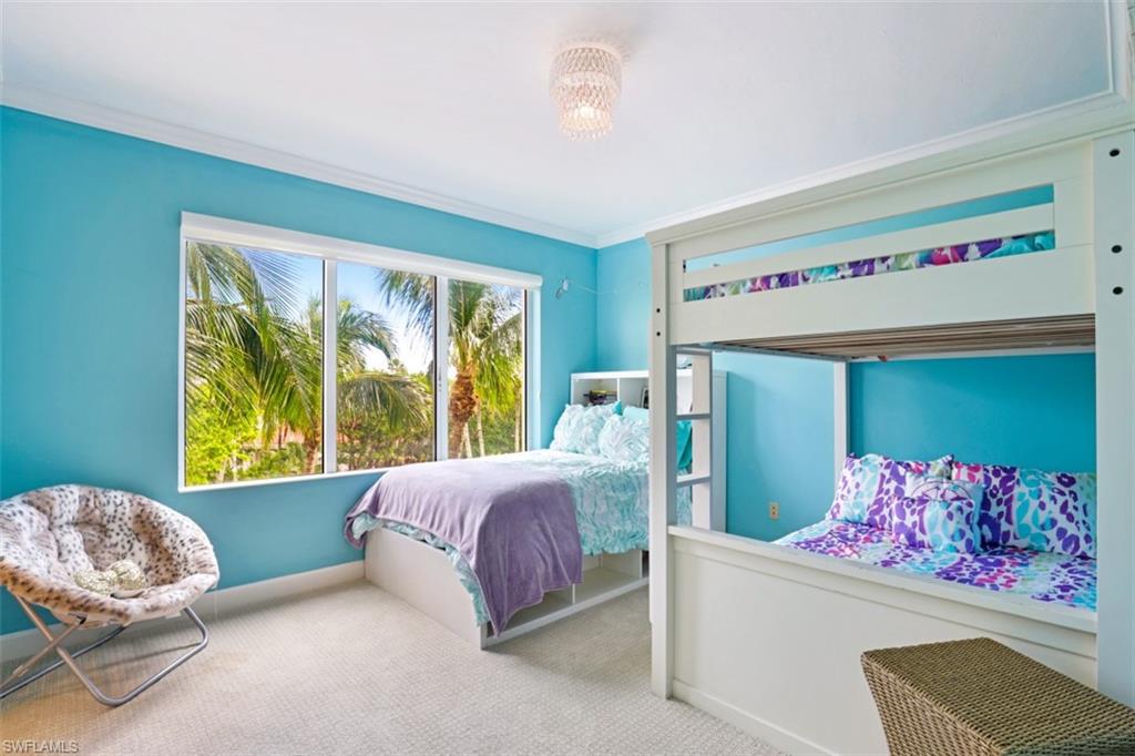 8720 Bay Colony Drive, Unit 304 Naples, FL 34108 - Photo 14 of 18 a bedroom with a bed and a couch