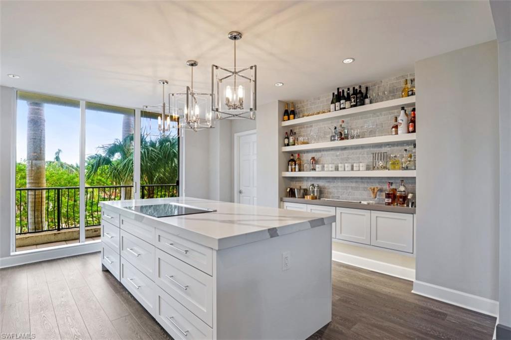 8720 Bay Colony Drive, Unit 304 Naples, FL 34108 - Photo 2 of 18 a room with kitchen island granite countertop lots of counter top space and wooden floor