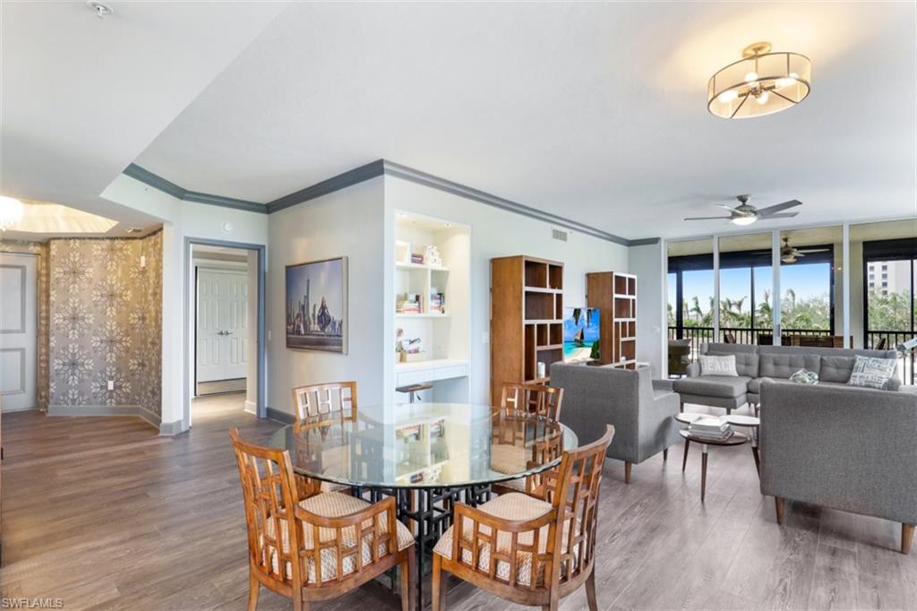 8720 Bay Colony Drive, Unit 304 Naples, FL 34108 - Photo 8 of 18 a view of a dining room with furniture window and wooden floor