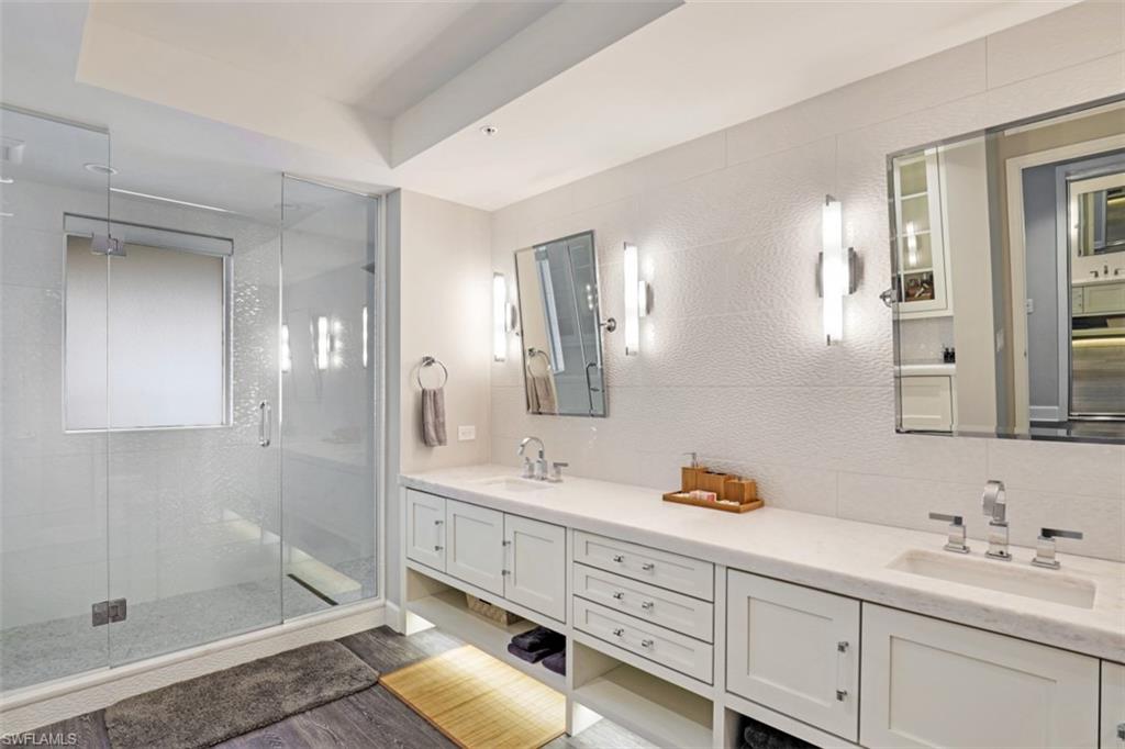 8720 Bay Colony Drive, Unit 304 Naples, FL 34108 - Photo 10 of 18 a bathroom with double sink and a mirror