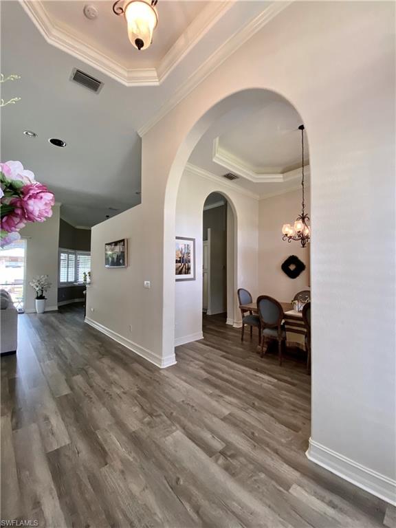 14826 Tybee Island Drive Naples, FL 34119 - Photo 1 of 20 a view of living room with furniture and wooden floor