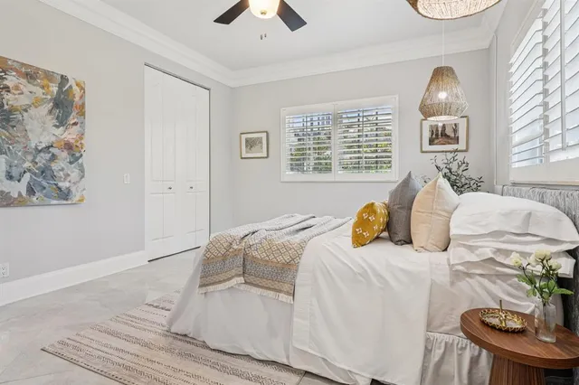 a bedroom with a bed and a painting on the wall