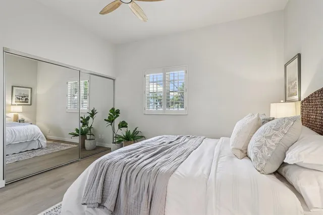 a bedroom with a large bed and a chandelier