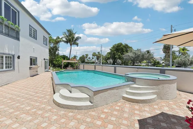 a view of a patio with couches and potted plants