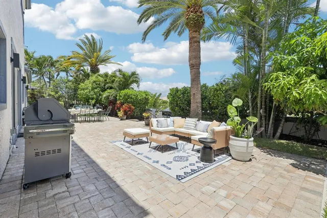 a view of a backyard with furniture and a garden